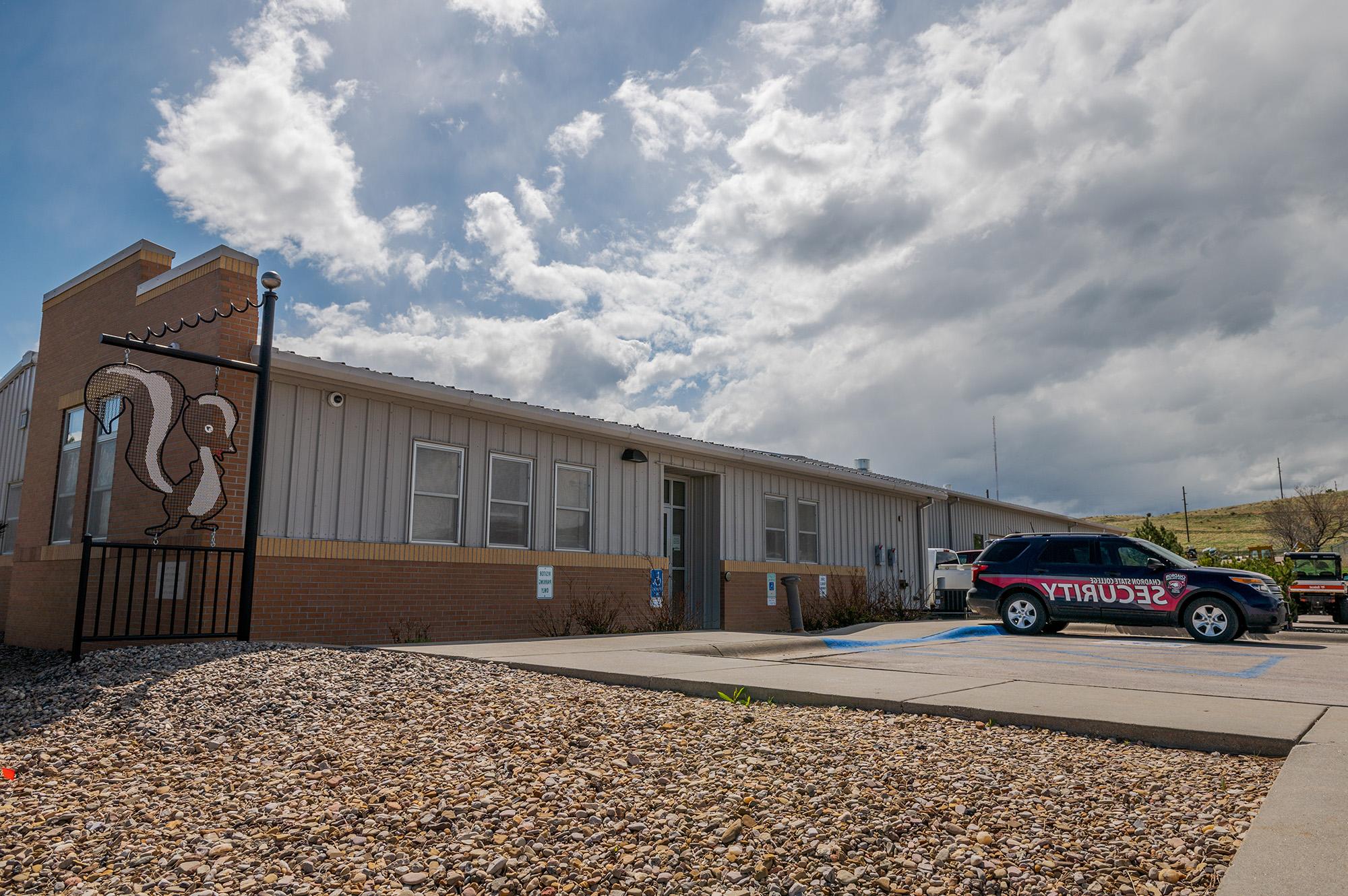 Photo of the maintence building with a security vehicle parked in front